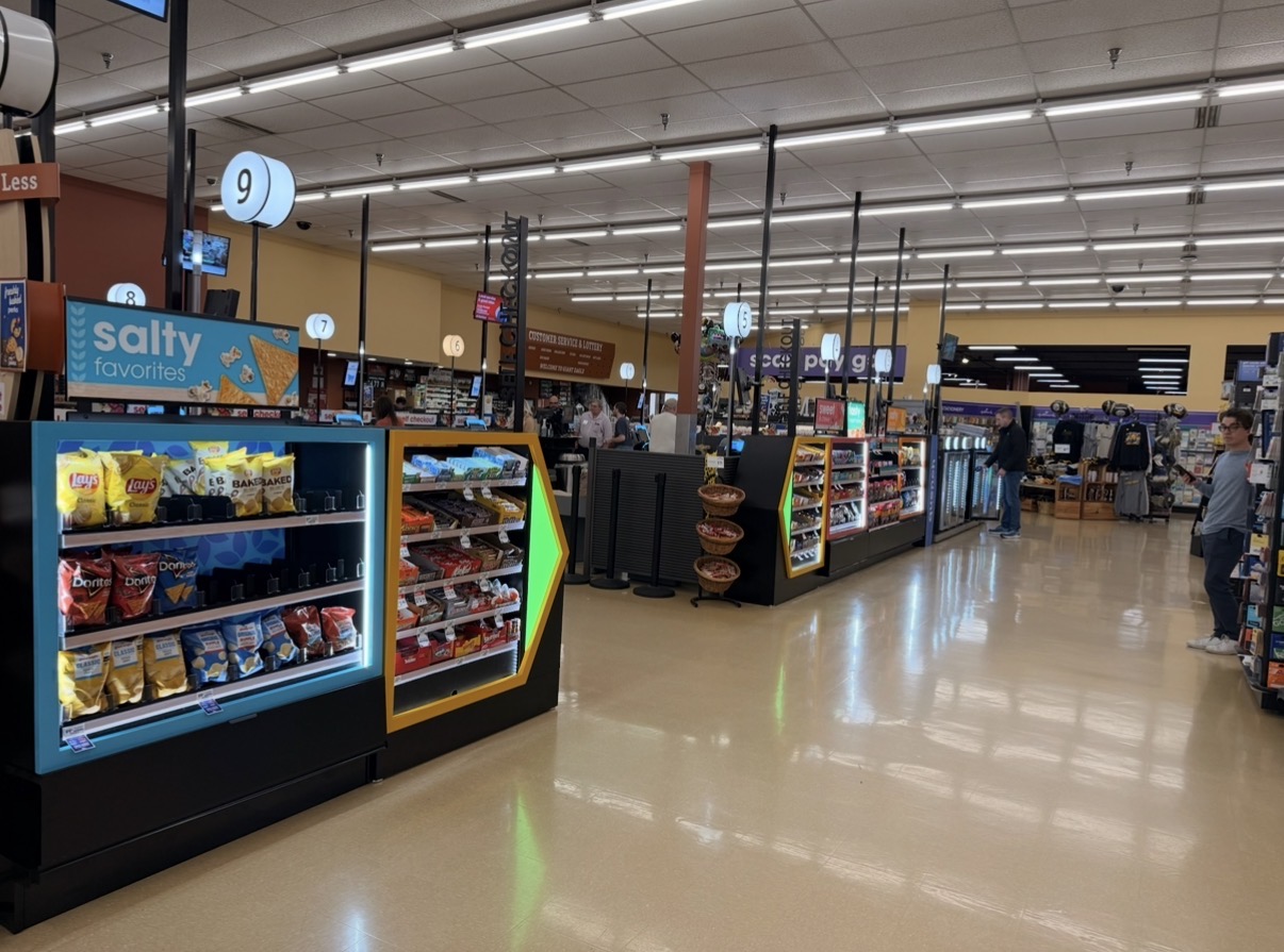 Grocery checkout merchandising — Base Built fixture run with category branding
